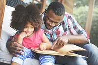 Father reading to daughter